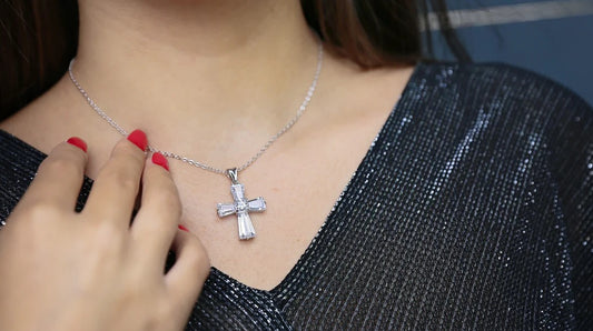 A woman wearing a silver cross necklace, symbolizing faith and inspiring Christian jewelry for women.